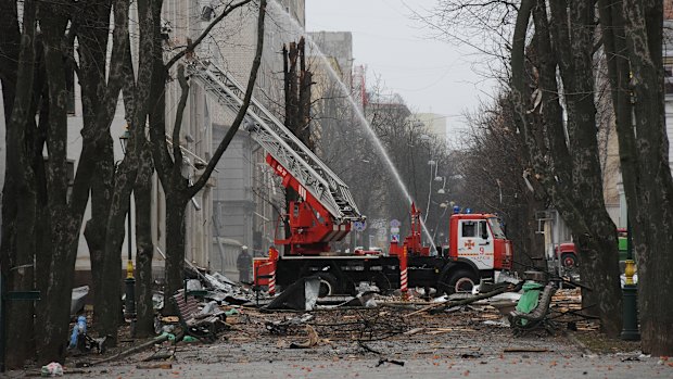 Firefighters extinguish a building after a rocket attack in Kharkiv.