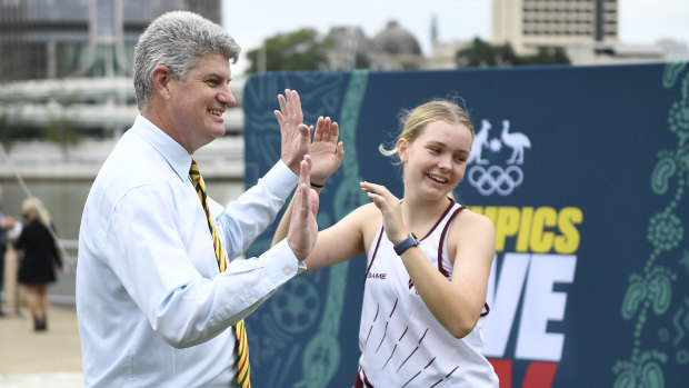 Minister for Sport Stirling Hinchliffe high-fives a young athlete during the Australian Olympic Committee announcement of Olympics locations.