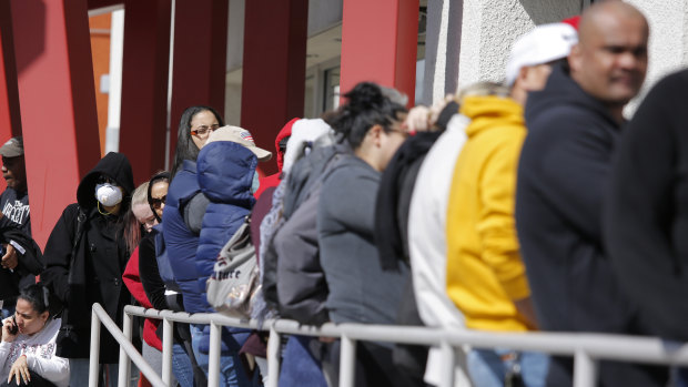 People wait in line to register for unemployment benefits in Las Vegas in March.