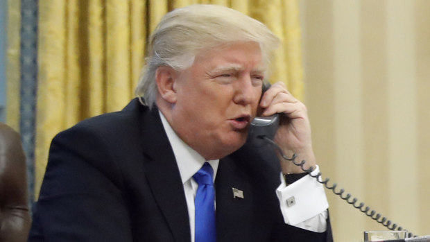 US President Donald Trump working the phone. 