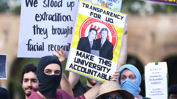 Students hold placards demanding transparency from UQ at Wednesday's protest.