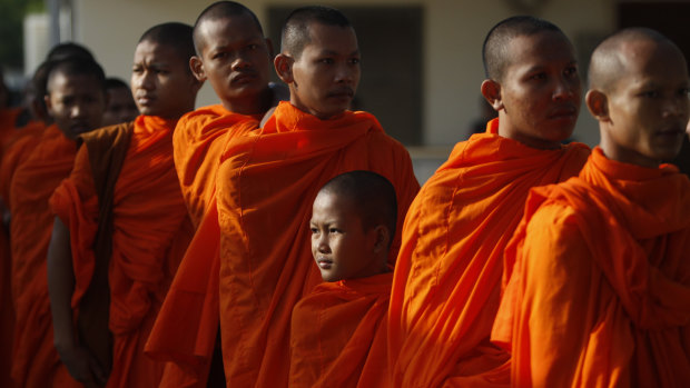 Cambodian Buddhist monks wait in queue to enter the courtroom before the hearings against two former Khmer Rouge senior leaders.