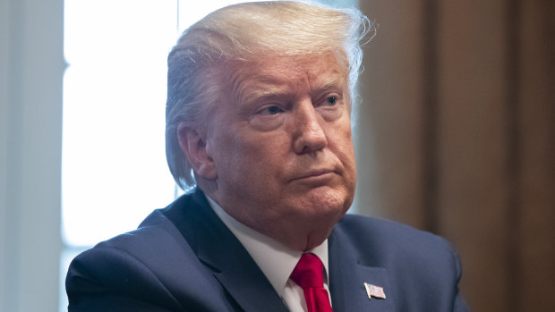 US President Donald Trump listens to updates about the coronavirus in the Cabinet Room of the White House.