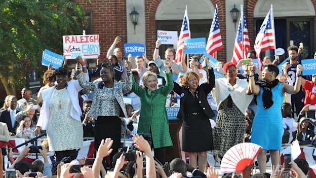 Hillary Clinton on the campaign trail in 2016 with mothers of children killed by gun or police violence. Lucy McBath is to the right of Clinton.