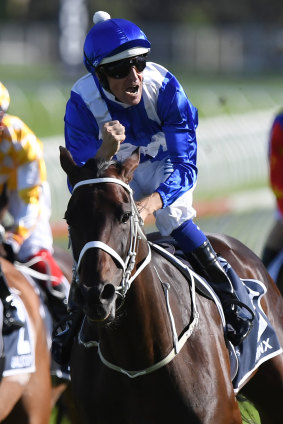 Celebration: Bowman has time to enjoy the moment as Winx canters past the post.