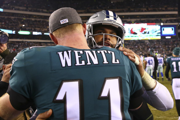 Carson Wentz and Dak Prescott hug after the Eagles beat the Cowboys.