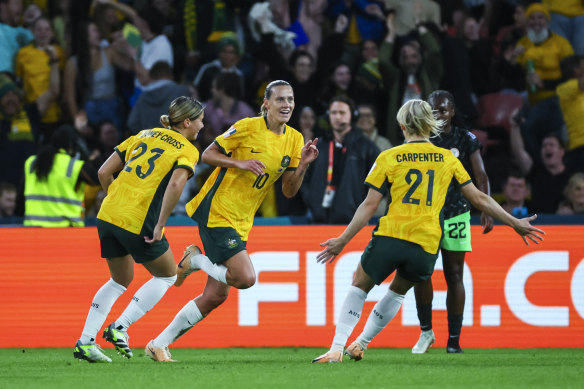 Australia’s Emily Van Egmond, centre, celebrates with teammates after scoring the opening goal against Nigeria.