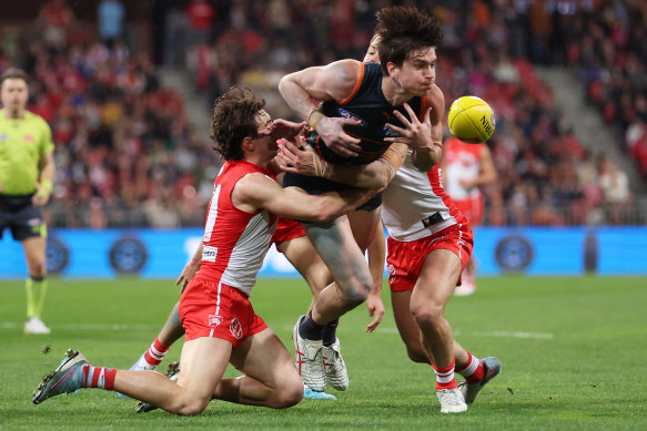 Hold it right there: Sam Taylor of the Giants is dispossessed against the Swans.