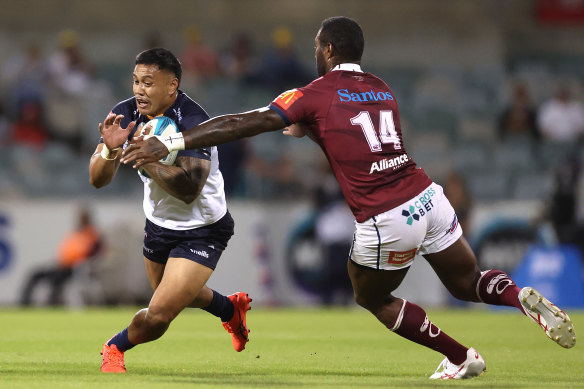 Len Ikitau of the Brumbies is tackled by Suliasi Vunivalu of the Reds during the round 3 encounter.