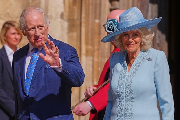 King Charles and Queen Camilla greet crowds.