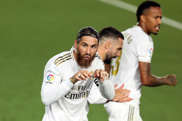 Real Madrid's Sergio Ramos celebrates the penalty which put one hand on the La Liga trophy for his side.