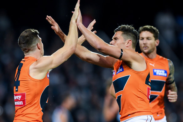 Toby Greene of the Giants celebrates a goal with Josh Kelly of the Giants.