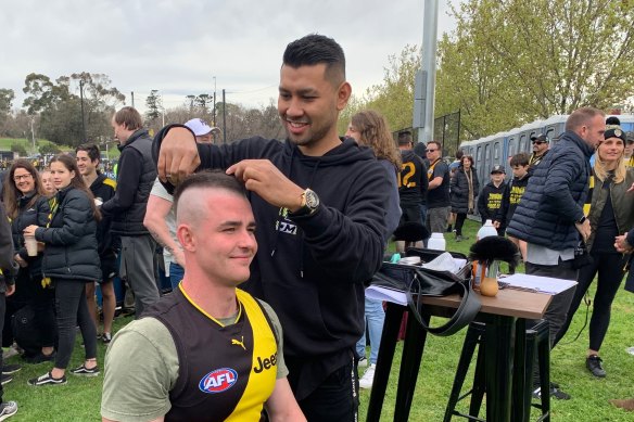 Dusty Martin’s barber Sakkarin Onnom giving Nick Greig a “DMV”.