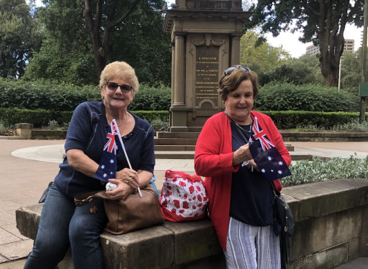 Merrilyn Taylor (red top) and Sylvia Campbell watching the Anzac Day march.