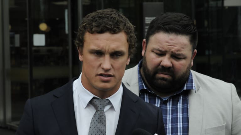 Canberra Raiders fullback Jack Wighton (left), supported by former NRL player George Rose apologises for his behaviour outside ACT courts on Wednesday.