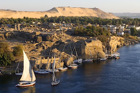 Feluccas moored at the ancient ruins of Swenet on Elephantine Island in Aswan.