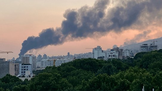Smoke rises from the building of Iran’s state-run television after an Israeli strike in Tehran.