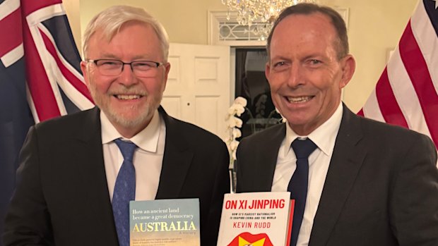 Former prime ministers Tony Abbott and Kevin Rudd brandishing each other’s books while in Washington.