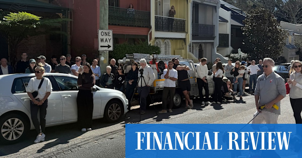 About 100 people watched the sale of a rundown terrace in affluent Paddington, as sellers were warned to consider their pricing expectations going into spring.