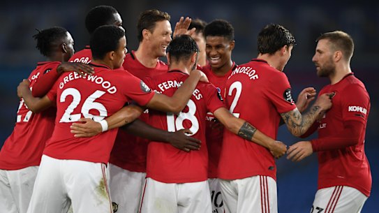 Bruno Fernandes is mobbed by his United teammates.