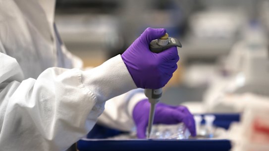 Scientist Xinhua Yan works in the lab at biotech Moderna.