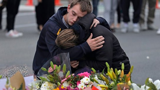 Mourners pay their respects at a makeshift memorial near the Masjid Al Noor mosque in Christchurch. Australian police on Monday raided properties in Australia in relation to Friday's massacre.
