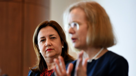 Queensland Premier Annastacia Palaszczuk (left) watches Queensland Chief Health Officer Dr Jeannette Young 