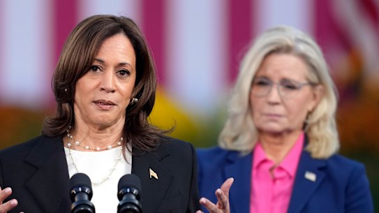 Democratic presidential nominee Vice President Kamala Harris speaks with former representative Liz Cheney, at a campaign rally in Wisconsin.