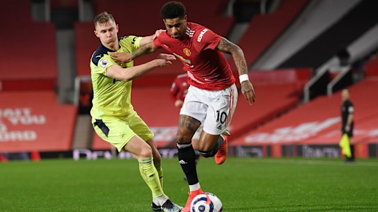 Marcus Rashford and Newcastle’s Emil Krafth jostle for possession at Old Trafford.