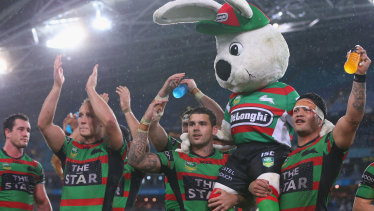 Adam Reynolds and Issac Luke carry Reggie the Rabbit from the field after the passing of Charlieâs wife back in 2013.