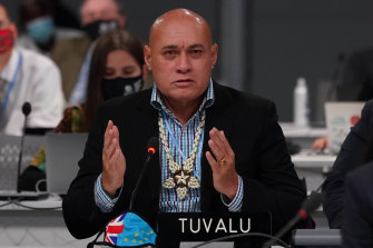 Tuvalu Finance Minister Seve Paeniu holds back tears while speaking.