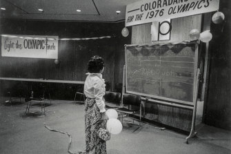  A lone celebrant quietly views tally board at the Denver Olympic Committee victory headquarters.