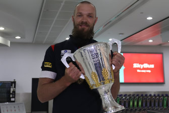 Max Gawn holds the premiership cup.
