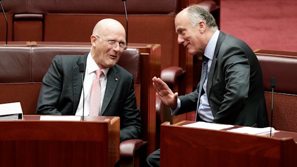 Senators David Leyonhjelm and Eric Abetz in discussion during debate in the Senate at Parliament House in Canberra on  Wednesday.