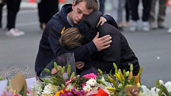 Mourners pay their respects at a makeshift memorial near the Masjid Al Noor mosque in Christchurch. Police on Monday raided properties in Australia in relation to Friday's massacre.