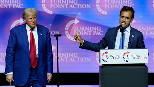 Donald Trump listens as Vivek Ramaswamy speaks during a campaign rally in October.