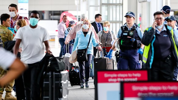 People arriving from overseas were met by police officers at Sydney Airport on Sunday morning. 