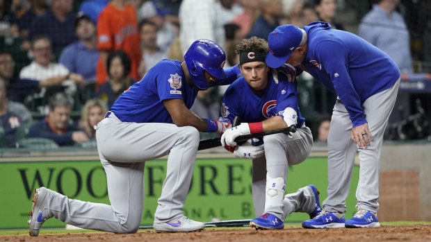 Chicago Cubs' Albert Almora Jr (centre) is consoled by Jason Heyward (left) and manager Joe Maddon after hitting a foul ball into the stands.