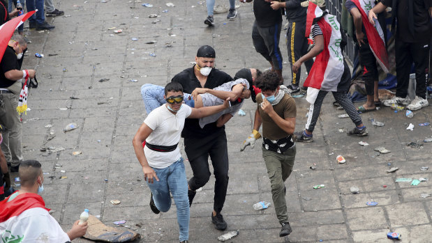 An injured protester is rushed to a hospital during a demonstration in Baghdad.