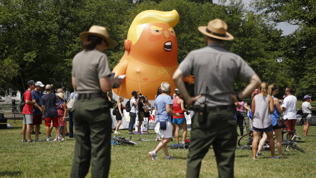 National Park Service rangers view a Baby Trump balloon before Independence Day celebrations. Protesters did not get permission to fly the balloon.
