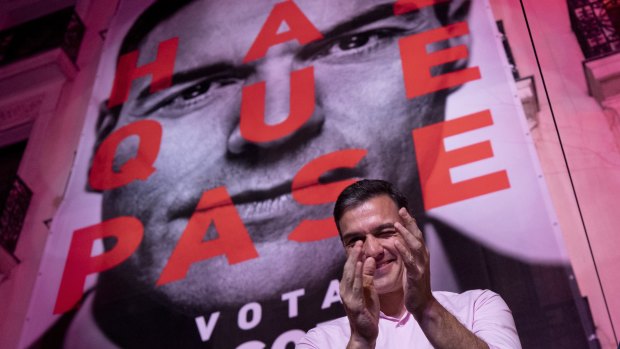 Spain's Prime Minister and Socialist Party leader Pedro Sanchez winks to supporters outside the party headquarters following the general election in Madrid, Spain. 