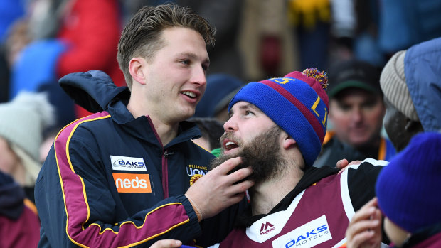 'It's going to be a massive game': Alex Witherden (left, with a fan) and the Lions are expecting a near sell-out at the Gabba on Saturday.