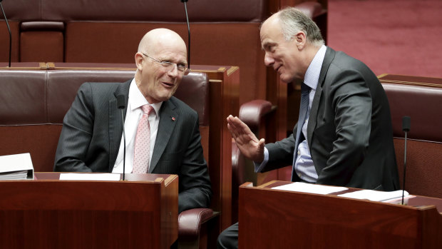 Senators David Leyonhjelm and Eric Abetz in discussion during debate in the Senate at Parliament House in Canberra on  Wednesday.