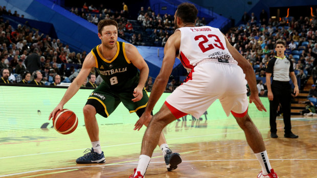 Matthew Dellavedova of the Boomers comes up against Phil Scrubb of Canada on Friday night.