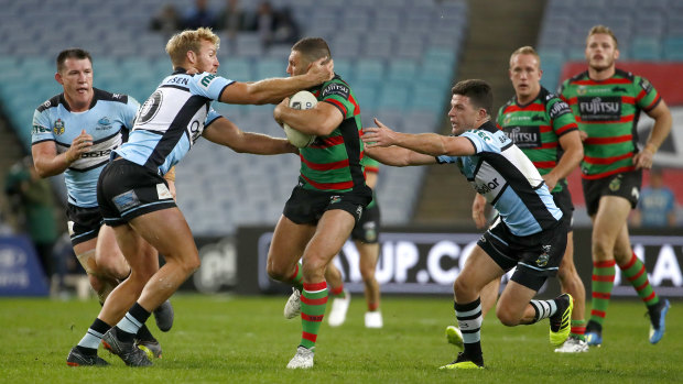 Strong carry: Robbie Farah of the Rabbitohs is tackled in his first NRL appearance this season.