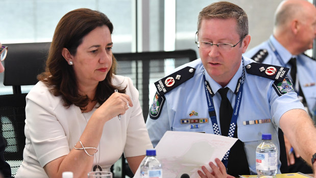 Queensland Premier Annastacia Palaszczuk (left) with Emergency Services deputy commissioner Bob Gee (right) .