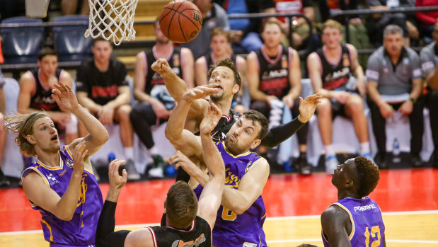 Sydney Kings centre Andrew Bogut fights for the ball in the key during the pre-season match against Illawarra Hawks opponent David Andersen.
