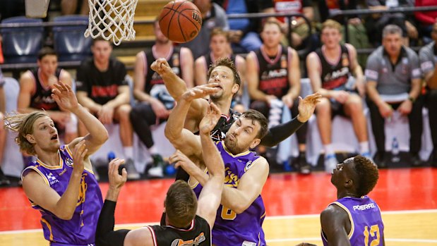 Sydney Kings centre Andrew Bogut fights for the ball in the key during the pre-season match against Illawarra Hawks opponent David Andersen.