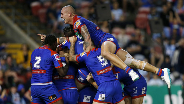 Pile on: Newcastle celebrate Tim Glasby's opening try in the Knights' win over Cronulla.