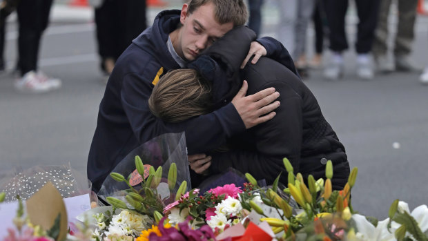 Mourners pay their respects at a makeshift memorial near the Masjid Al Noor mosque in Christchurch. Police on Monday raided properties in Australia in relation to Friday's massacre.